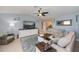 Inviting living room featuring a large TV, coastal decor, and ample seating space at 129 Barre Nw Dr, Port Charlotte, FL 33952