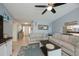 Cozy living room with light blue walls, comfortable seating, and a stylish ceiling fan at 129 Barre Nw Dr, Port Charlotte, FL 33952