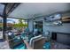 Comfortable outdoor living space with a ceiling fan, TV, and plenty of seating at 129 Barre Nw Dr, Port Charlotte, FL 33952