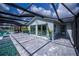 Spacious outdoor patio next to pool, featuring stylish pavers and seamless access to indoor living spaces at 129 Barre Nw Dr, Port Charlotte, FL 33952