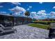 Relaxing patio area features chaise lounges, an enclosed patio, and waterfront views at 129 Barre Nw Dr, Port Charlotte, FL 33952