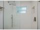 The walk-in shower features a rainfall shower head, and wave-style tiles at 129 Barre Nw Dr, Port Charlotte, FL 33952
