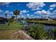 Waterfront property with mature landscaping along canal at 129 Barre Nw Dr, Port Charlotte, FL 33952