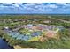Aerial view of the country club highlighting golf course, pool, tennis courts and well maintained landscape at 13049 Creekside Ln, Port Charlotte, FL 33953