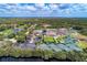 Aerial view of the country club offering multiple tennis courts, golf course and pristine landscape at 13049 Creekside Ln, Port Charlotte, FL 33953