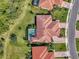 Bird's-eye view features a home with a screened pool and a perfectly manicured lawn in a residential neighborhood at 13049 Creekside Ln, Port Charlotte, FL 33953