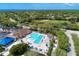 Community aerial view featuring pool, clubhouse, golf, parking and well-maintained landscape at 13049 Creekside Ln, Port Charlotte, FL 33953