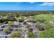 High-angle shot reveals a golf course community near a clubhouse, lake, and parking area at 13049 Creekside Ln, Port Charlotte, FL 33953