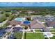 Aerial view of clubhouse, pool, parking, common areas, and surrounding greenery at 13049 Creekside Ln, Port Charlotte, FL 33953