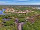 Idyllic aerial shot showcases a home nestled in a community near a calm lake and wooded area at 13049 Creekside Ln, Port Charlotte, FL 33953