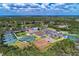 Drone shot featuring tennis and pickleball courts, dog park, golf course, and beautiful landscape at 13049 Creekside Ln, Port Charlotte, FL 33953