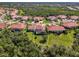 Residential neighborhood aerial view showing backyard, pool, and green space at 13049 Creekside Ln, Port Charlotte, FL 33953