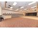 Large ballroom with a stage, performance lighting, piano, hardwood floor, and seating area for events at 13049 Creekside Ln, Port Charlotte, FL 33953