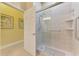 Accessible bathroom with a glass enclosed shower, grab bars, and tile surround at 13049 Creekside Ln, Port Charlotte, FL 33953
