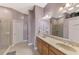 Bathroom featuring double sinks, granite countertops, and a glass-enclosed shower at 13049 Creekside Ln, Port Charlotte, FL 33953