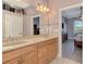 Bathroom features double sinks, granite countertops, and an en-suite bedroom view at 13049 Creekside Ln, Port Charlotte, FL 33953