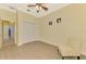 Bright bedroom featuring a chair, closet, and neutral color palette at 13049 Creekside Ln, Port Charlotte, FL 33953