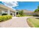 Beautiful building with a paver driveway, manicured landscaping, and inviting entryway, creating curb appeal at 13049 Creekside Ln, Port Charlotte, FL 33953