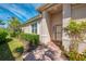 Inviting front entrance featuring a brick walkway, and lush landscaping at 13049 Creekside Ln, Port Charlotte, FL 33953