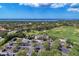Scenic aerial view of the golf course, lakes, and lush greenery, creating a picturesque landscape and vibrant community at 13049 Creekside Ln, Port Charlotte, FL 33953