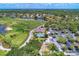 Aerial view of the golf course with manicured greens, a serene lake, and residential homes in a well-maintained community at 13049 Creekside Ln, Port Charlotte, FL 33953