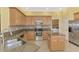 Well-appointed kitchen boasts stainless steel appliances, granite counters, and convenient access to the laundry room at 13049 Creekside Ln, Port Charlotte, FL 33953