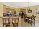 Eat-in kitchen features granite countertops, stainless steel appliances, and a breakfast bar with seating at 13049 Creekside Ln, Port Charlotte, FL 33953
