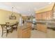 Bright kitchen with stainless steel appliances, granite countertops, and island with seating overlooking the living areas at 13049 Creekside Ln, Port Charlotte, FL 33953