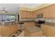 Stylish kitchen with stainless steel appliances, island with granite counters, and ample cabinet storage at 13049 Creekside Ln, Port Charlotte, FL 33953