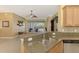 Granite counters, stainless appliances & backsplash accent the breakfast bar between the kitchen and living room at 13049 Creekside Ln, Port Charlotte, FL 33953