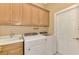 Functional laundry room with washer, dryer, sink, and ample cabinet space at 13049 Creekside Ln, Port Charlotte, FL 33953
