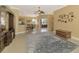 Spacious living room with tile floors, ceiling fan, and access to the kitchen and dining area at 13049 Creekside Ln, Port Charlotte, FL 33953