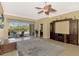 Spacious living area with access to screened-in lanai and a custom entertainment center at 13049 Creekside Ln, Port Charlotte, FL 33953