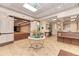 Elegant lobby with a tiled floor, floral arrangement, reception desk, and doorway to a large meeting room at 13049 Creekside Ln, Port Charlotte, FL 33953
