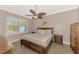 Spacious bedroom with a large window, ceiling fan, and coordinating furniture at 13049 Creekside Ln, Port Charlotte, FL 33953