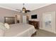 Well-lit bedroom with en-suite bathroom, ceiling fan, and classic furnishings at 13049 Creekside Ln, Port Charlotte, FL 33953