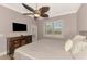 Cozy bedroom featuring neutral decor, ceiling fan, and a view to the pool area at 13049 Creekside Ln, Port Charlotte, FL 33953