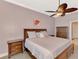 Comfortable bedroom boasts a ceiling fan, soft lighting, and classic furnishings at 13049 Creekside Ln, Port Charlotte, FL 33953