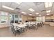 Spacious meeting room with multiple tables and chairs, plus cabinets for storage at 13049 Creekside Ln, Port Charlotte, FL 33953