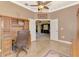 Elegant office space with wooden desk, chair, and doorway to adjoining room at 13049 Creekside Ln, Port Charlotte, FL 33953
