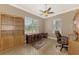 Bright office space featuring a large window, hardwood floors, and built-in shelving at 13049 Creekside Ln, Port Charlotte, FL 33953