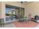 Covered patio with outdoor furniture and sliding glass doors to interior of home at 13049 Creekside Ln, Port Charlotte, FL 33953