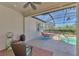 Covered patio with a ceiling fan, string lights, outdoor furniture, and pool views at 13049 Creekside Ln, Port Charlotte, FL 33953