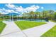 Outdoor pickleball courts feature a shaded seating area and a well-maintained landscape in this active community at 13049 Creekside Ln, Port Charlotte, FL 33953