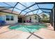 Screened pool area featuring a swimming pool and attached hot tub at 13049 Creekside Ln, Port Charlotte, FL 33953
