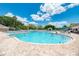 Large community pool featuring inviting blue water and spacious lounging areas for residents to relax and socialize in the sun at 13049 Creekside Ln, Port Charlotte, FL 33953
