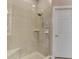 Modern bathroom with a glass-door shower, tiled walls, and built-in shelving at 13049 Creekside Ln, Port Charlotte, FL 33953