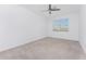 Bedroom featuring a ceiling fan, neutral carpet and a window at 14632 Sycamore Ct # 2621, Punta Gorda, FL 33955