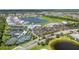 Scenic aerial view showcasing the community amenities, including tennis courts and a central lake at 14724 Cherry Blossom Way, Punta Gorda, FL 33955