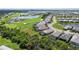 Scenic aerial view of a home with a screened pool in a community near a golf course at 14724 Cherry Blossom Way, Punta Gorda, FL 33955